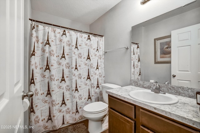 bathroom featuring vanity, a textured ceiling, and toilet