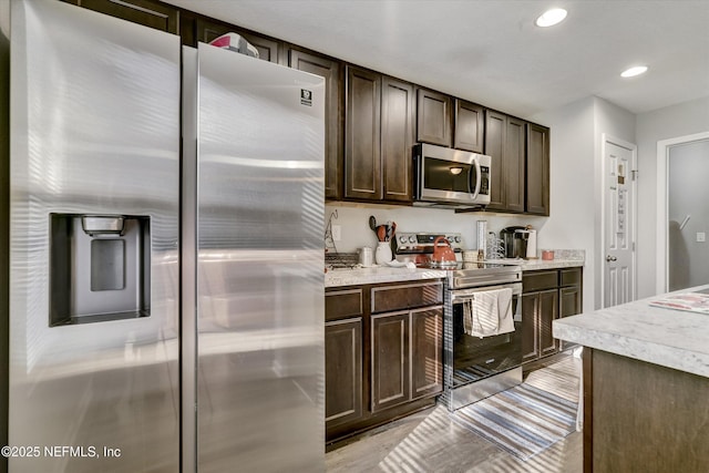 kitchen featuring dark brown cabinetry and stainless steel appliances