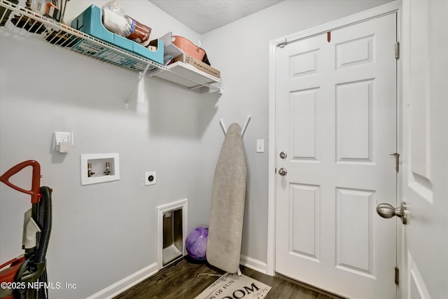 clothes washing area featuring washer hookup, dark hardwood / wood-style flooring, a textured ceiling, and electric dryer hookup