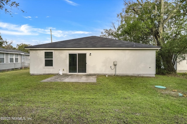 rear view of property with a patio area and a yard