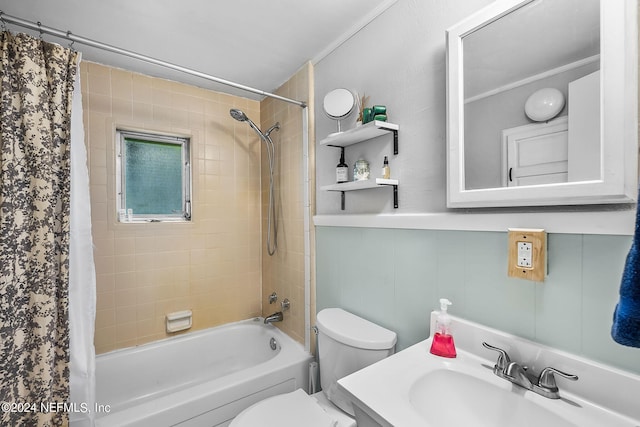 full bathroom with shower / bathtub combination with curtain, vanity, and toilet