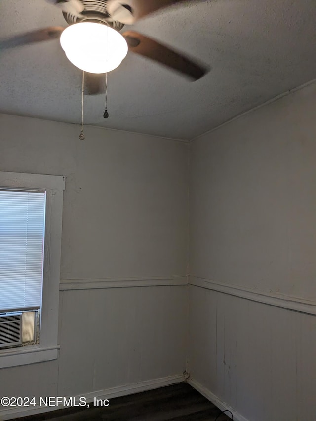 spare room featuring ceiling fan, dark hardwood / wood-style flooring, and cooling unit