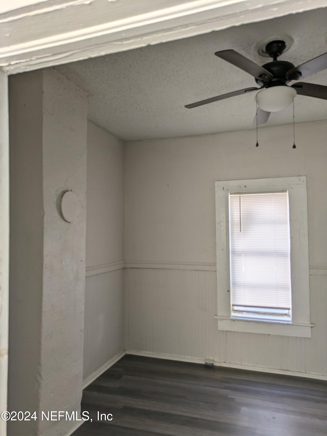 spare room with ceiling fan and dark hardwood / wood-style flooring