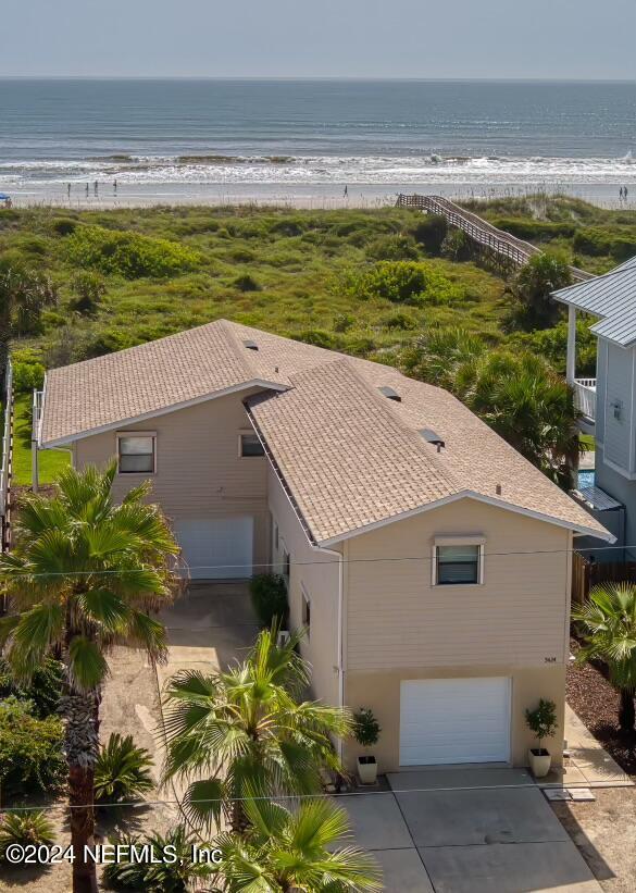 birds eye view of property featuring a water view and a view of the beach