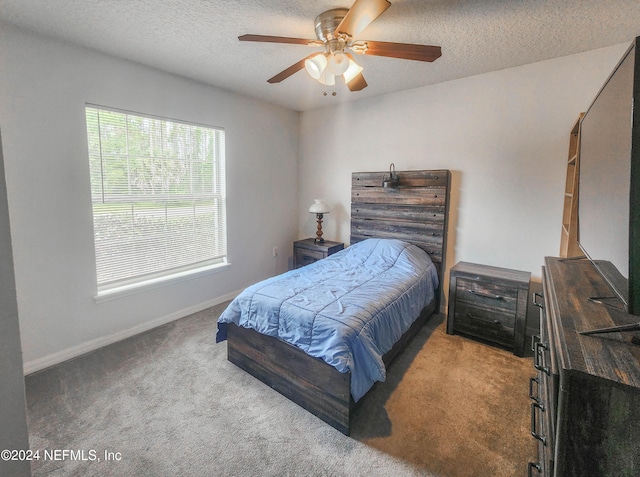 carpeted bedroom with ceiling fan and a textured ceiling