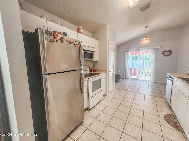 kitchen with appliances with stainless steel finishes, a textured ceiling, white cabinets, hanging light fixtures, and lofted ceiling