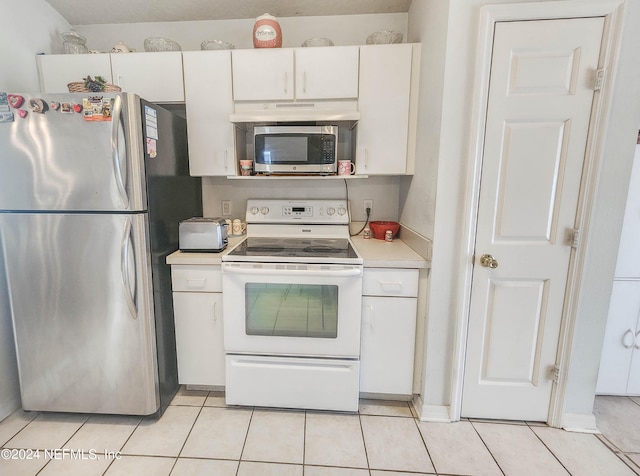 kitchen featuring light tile patterned flooring, white cabinetry, and appliances with stainless steel finishes