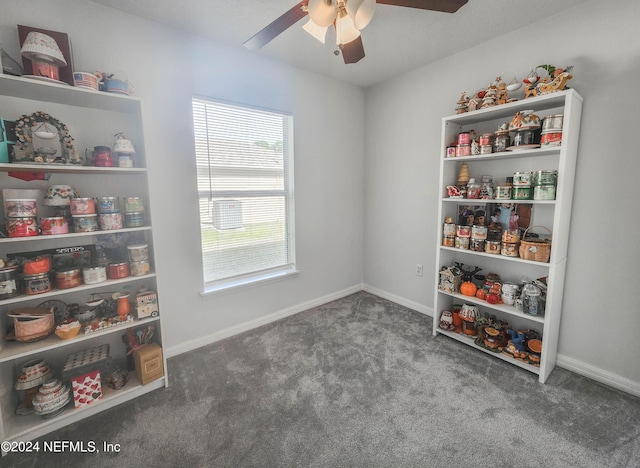 recreation room with dark carpet and ceiling fan