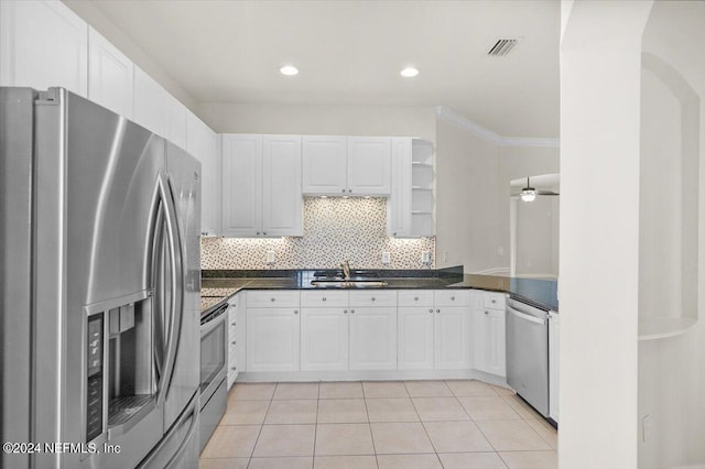 kitchen with sink, ceiling fan, light tile patterned floors, appliances with stainless steel finishes, and white cabinetry