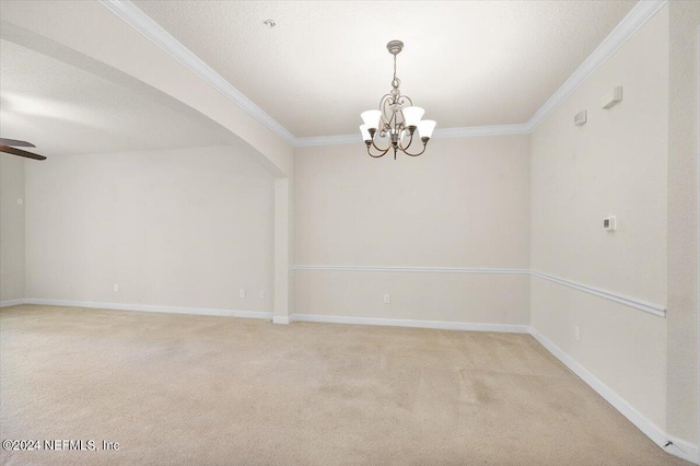 carpeted empty room featuring ceiling fan with notable chandelier, a textured ceiling, and ornamental molding