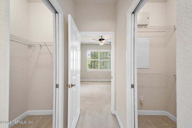 interior space with light carpet and ceiling fan