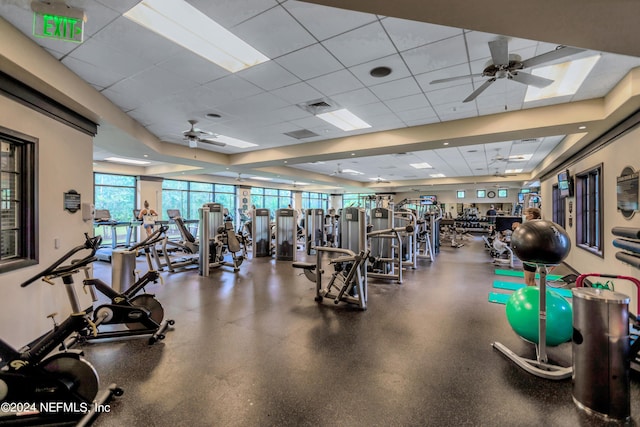 exercise room with a paneled ceiling and ceiling fan