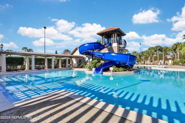 view of swimming pool with a water slide