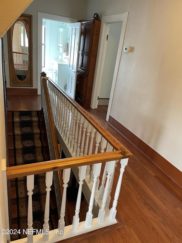 staircase with hardwood / wood-style flooring