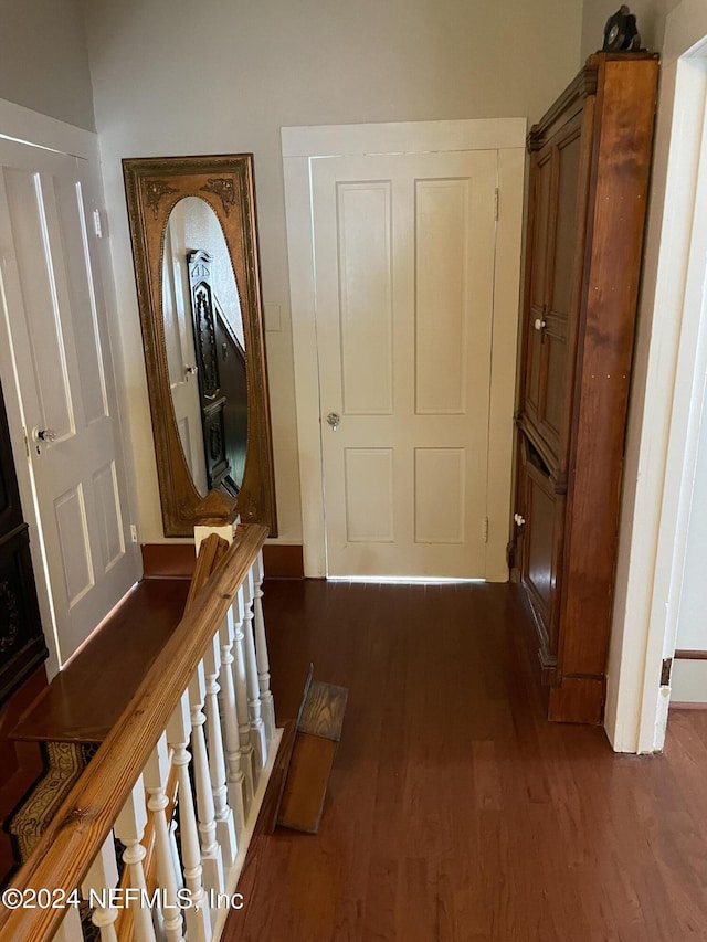 hallway with dark hardwood / wood-style floors