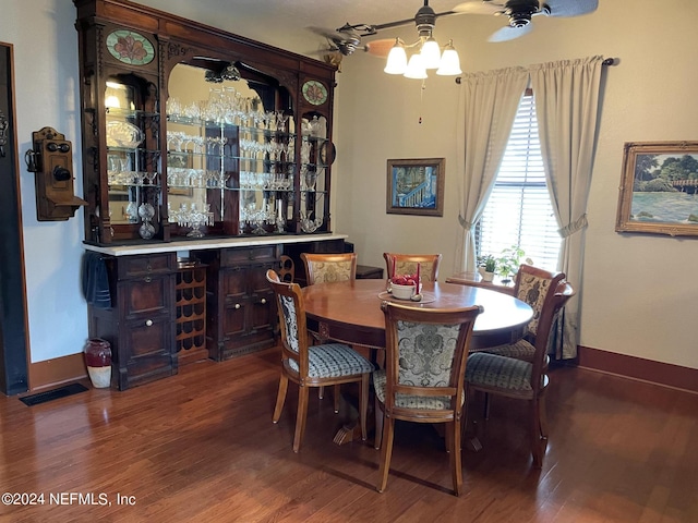 dining room featuring hardwood / wood-style flooring and indoor bar