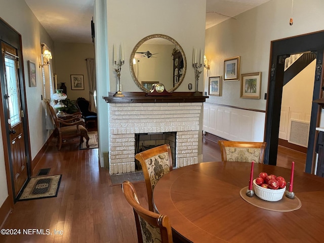 dining space featuring dark hardwood / wood-style floors and a fireplace