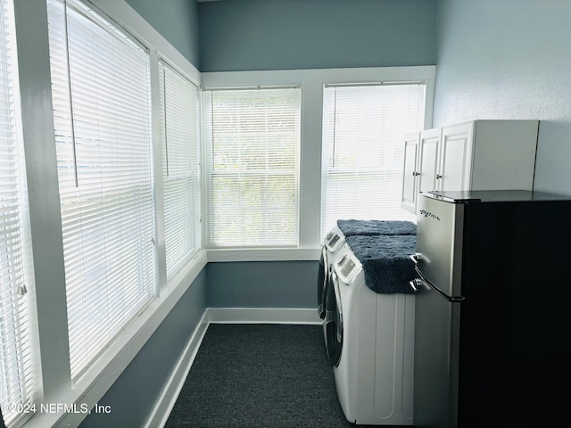 interior space with washing machine and dryer and dark colored carpet