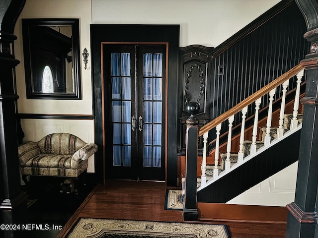 foyer featuring dark wood-type flooring and french doors