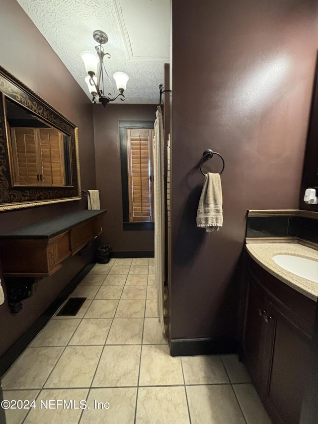 bathroom featuring vanity, a chandelier, tile patterned floors, and a textured ceiling