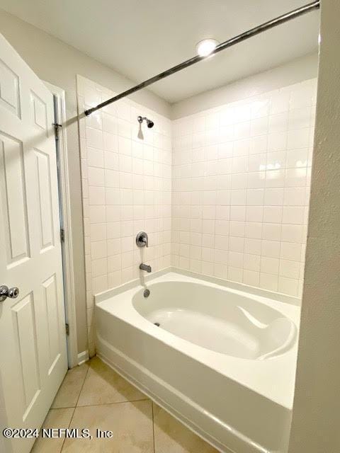 bathroom with tile patterned floors and tiled shower / bath