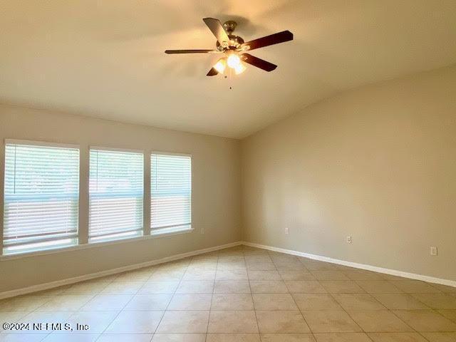 unfurnished room with ceiling fan and lofted ceiling