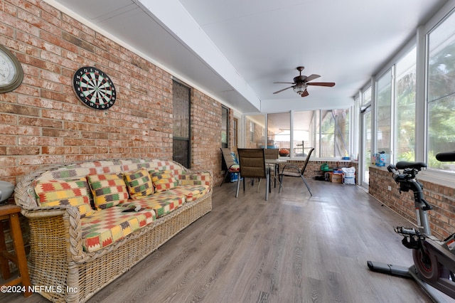 sunroom / solarium featuring plenty of natural light and ceiling fan