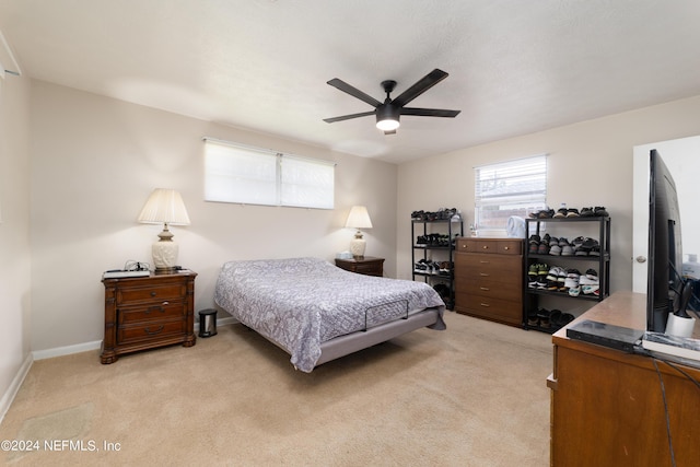 bedroom with light colored carpet and ceiling fan