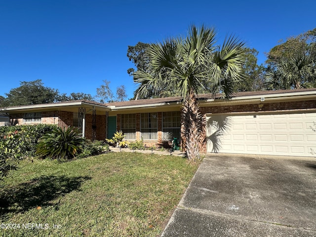 single story home with a garage and a front yard