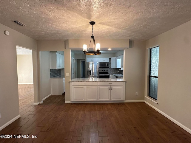 kitchen with decorative backsplash, light stone counters, white cabinetry, and appliances with stainless steel finishes