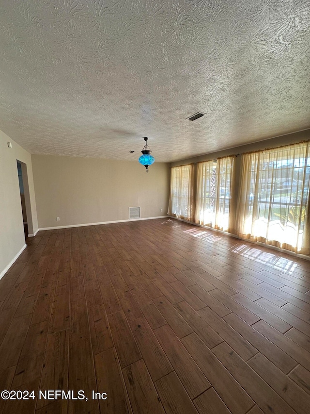 spare room featuring dark hardwood / wood-style floors