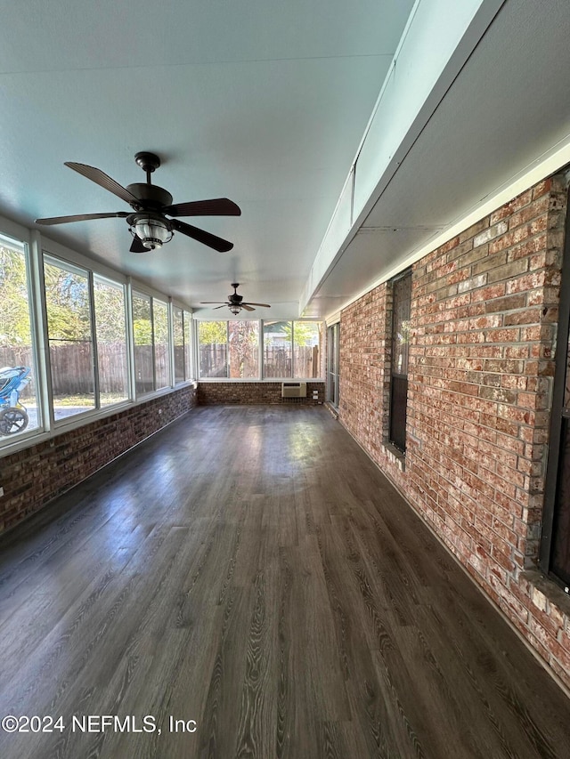 interior space with ceiling fan and an AC wall unit