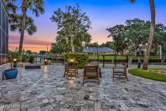 patio terrace at dusk with glass enclosure and fence