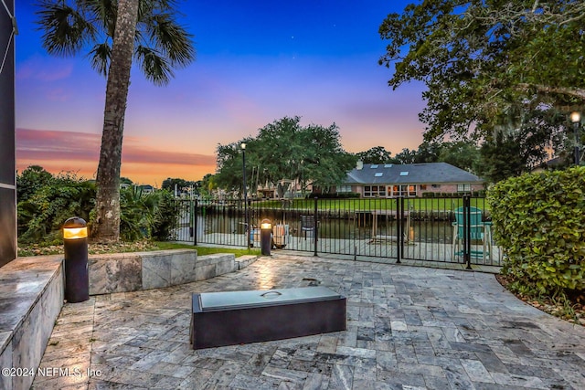 exterior space with a water view and fence