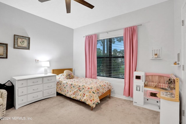 bedroom featuring light colored carpet and ceiling fan