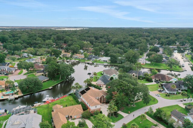 drone / aerial view featuring a water view and a residential view