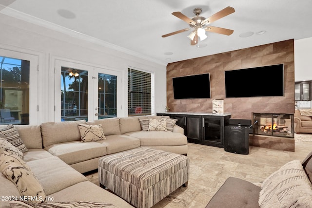 living area featuring ornamental molding, a fireplace, and ceiling fan