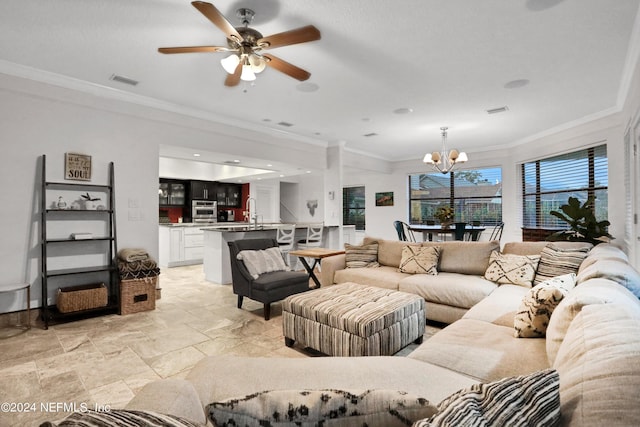 living room featuring ceiling fan with notable chandelier, stone finish flooring, visible vents, and crown molding