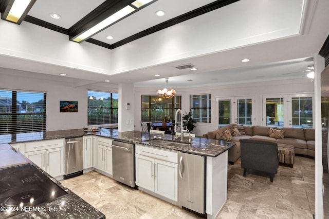 kitchen featuring visible vents, dark stone counters, ornamental molding, black electric stovetop, and a sink