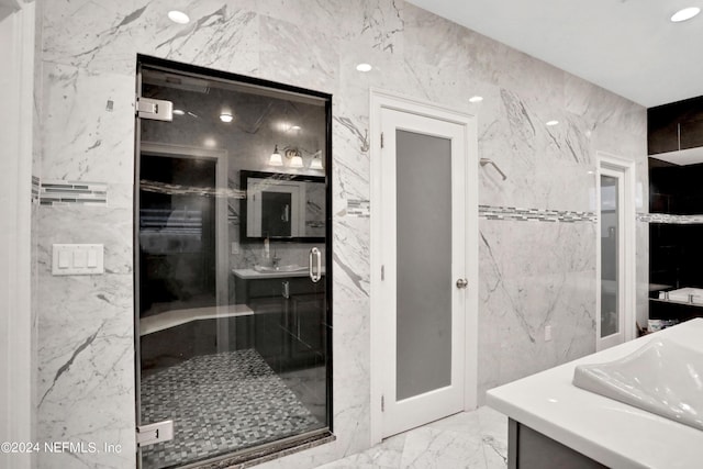 bathroom with a stall shower, marble finish floor, and stone wall