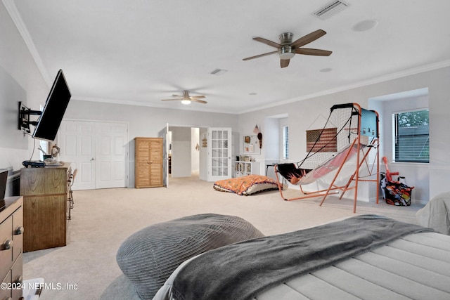 carpeted bedroom with french doors, ornamental molding, multiple windows, and visible vents