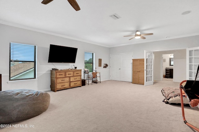 interior space featuring ceiling fan, carpet floors, ornamental molding, and visible vents