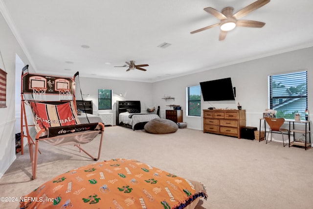 carpeted bedroom featuring visible vents, a ceiling fan, and crown molding