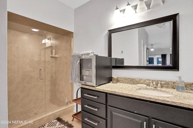 full bathroom with a shower stall and vanity