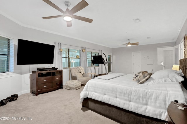 bedroom featuring light carpet, baseboards, visible vents, a ceiling fan, and ornamental molding