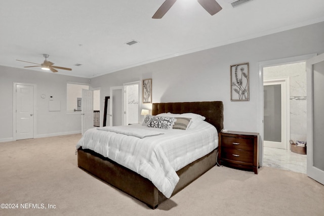 bedroom featuring baseboards, ornamental molding, visible vents, and light colored carpet