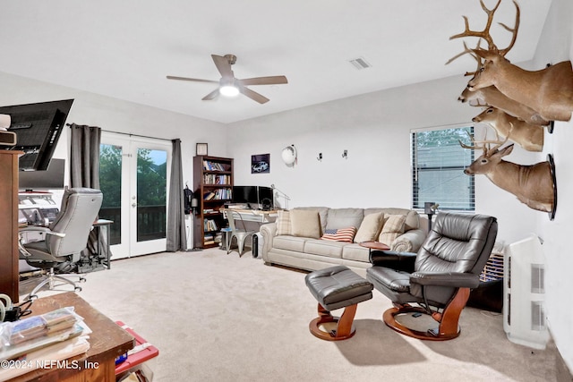 carpeted living room featuring ceiling fan, french doors, and visible vents