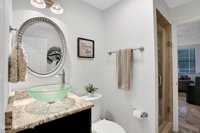 full bathroom with toilet, a shower stall, and vanity