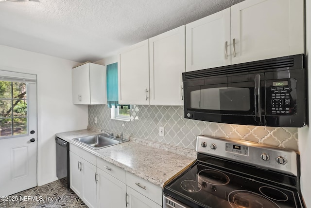 kitchen with black appliances, a healthy amount of sunlight, backsplash, and a sink