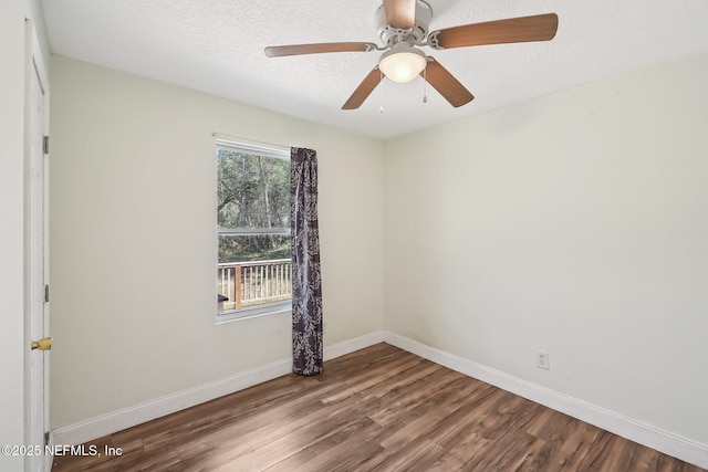 empty room with baseboards, a textured ceiling, and wood finished floors